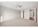 Spacious bedroom featuring plush carpet, a ceiling fan, and a sizable closet at 3822 E Amber Ln, Gilbert, AZ 85296