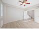 Spacious room with neutral walls, wood-look floors, ceiling fan, and interior entry door at 3822 E Amber Ln, Gilbert, AZ 85296