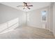 Bright bedroom with wood-look floors, ceiling fan, and two windows with plantation shutters at 3822 E Amber Ln, Gilbert, AZ 85296