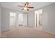 Bright and spacious bedroom featuring plush carpets, a ceiling fan, and a walk-in closet at 3822 E Amber Ln, Gilbert, AZ 85296