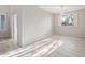 Neutral dining room with wood-look floors, natural light, and stylish chandelier at 3822 E Amber Ln, Gilbert, AZ 85296