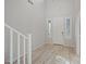 Bright foyer with soaring ceilings, wood-look floors, and staircase access to the upper level at 3822 E Amber Ln, Gilbert, AZ 85296