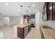 Well-lit kitchen features a center island, stainless appliances, and wood cabinets at 3822 E Amber Ln, Gilbert, AZ 85296