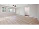 Spacious living room with wood flooring, and a large window with shade coverings at 3822 E Amber Ln, Gilbert, AZ 85296