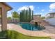 Backyard featuring a gorgeous pool with rock slide, spa and tall cypress trees offering extra privacy at 3822 E Amber Ln, Gilbert, AZ 85296