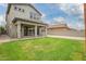 Spacious backyard featuring grass, gravel, and covered patio for outdoor enjoyment at 3938 E Appaloosa Rd, Gilbert, AZ 85296