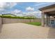 Backyard featuring gravel, grass, and a covered patio, all within a walled yard at 3938 E Appaloosa Rd, Gilbert, AZ 85296