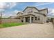 Large backyard with a mix of grass and gravel, complemented by a covered patio at 3938 E Appaloosa Rd, Gilbert, AZ 85296