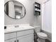 Clean white bathroom with storage shelves, mirror, and a shower-tub combo at 3938 E Appaloosa Rd, Gilbert, AZ 85296