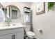 Charming bathroom with white vanity, round mirror, and decorative artwork at 3938 E Appaloosa Rd, Gilbert, AZ 85296