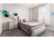 Charming bedroom with flower wall decor, a comfy bed, and a sunlit window at 3938 E Appaloosa Rd, Gilbert, AZ 85296