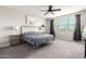Bright bedroom with large windows, neutral walls, patterned bedding, and a ceiling fan at 3938 E Appaloosa Rd, Gilbert, AZ 85296
