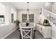 Bright dining room featuring an elegant chandelier, decorative cabinet, and staircase at 3938 E Appaloosa Rd, Gilbert, AZ 85296