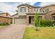 Charming two-story home with a well-manicured lawn, stone accents, and a two-car garage at 3938 E Appaloosa Rd, Gilbert, AZ 85296