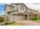 Charming two-story home with a well-manicured lawn, stone accents, and a two-car garage at 3938 E Appaloosa Rd, Gilbert, AZ 85296