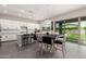 Bright, open kitchen with white cabinetry, granite countertops, stainless appliances, and sliding glass doors at 3938 E Appaloosa Rd, Gilbert, AZ 85296