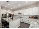Bright, open kitchen with white cabinets, granite countertops, stainless steel appliances at 3938 E Appaloosa Rd, Gilbert, AZ 85296