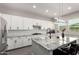 Spacious kitchen with white cabinetry, granite countertops, stainless appliances, and black hardware at 3938 E Appaloosa Rd, Gilbert, AZ 85296