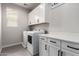 Well-lit laundry room with modern washer/dryer and plenty of cabinet space at 3938 E Appaloosa Rd, Gilbert, AZ 85296