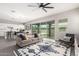 Open-concept living room with access to backyard, flowing into dining area with modern decor at 3938 E Appaloosa Rd, Gilbert, AZ 85296
