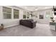 Spacious living room with plush gray sofa, neutral carpet, and plenty of natural light at 3938 E Appaloosa Rd, Gilbert, AZ 85296