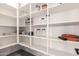 Walk-in pantry with white shelves, ample storage space, and wood-look floors at 3938 E Appaloosa Rd, Gilbert, AZ 85296
