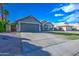 Well-maintained single-Gathering home boasts an oversized driveway and desert landscaping for low maintenance at 4050 E Encinas Ave, Gilbert, AZ 85234