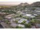 Desert community home featuring a pool, green landscaping, and mountain views at 4836 E Moonlight Way, Paradise Valley, AZ 85253