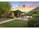 Inviting backyard featuring an outdoor lounge area, landscaped greenery, patio, pool and mountain views at 4836 E Moonlight Way, Paradise Valley, AZ 85253