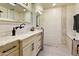 Bathroom featuring white vanity with granite countertop and tiled walk-in shower at 4836 E Moonlight Way, Paradise Valley, AZ 85253