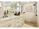 Bathroom featuring white vanity with granite countertop and tiled walk-in shower at 4836 E Moonlight Way, Paradise Valley, AZ 85253