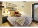 Comfortable bedroom featuring plush bedding, decorative pillows, unique mirrors, and a private door at 4836 E Moonlight Way, Paradise Valley, AZ 85253