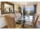Formal dining area featuring a glass table, chandelier, and large mirror at 4836 E Moonlight Way, Paradise Valley, AZ 85253