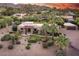 Expansive home with stone accents, mature landscaping, and a detached garage on a tree filled lot at 4836 E Moonlight Way, Paradise Valley, AZ 85253
