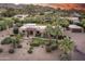 Stunning property featuring lush landscaping, a stone facade, barrel tile roof and mountain views at 4836 E Moonlight Way, Paradise Valley, AZ 85253