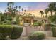 Charming property featuring a private bridge leading to a stone façade and lush, mature landscaping at 4836 E Moonlight Way, Paradise Valley, AZ 85253