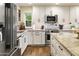 Bright kitchen featuring white cabinetry, stainless steel appliances, and granite countertops at 4836 E Moonlight Way, Paradise Valley, AZ 85253
