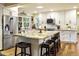 Spacious kitchen showcasing a large island, stainless steel appliances, and bar stool seating at 4836 E Moonlight Way, Paradise Valley, AZ 85253