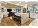 Open concept kitchen with an island featuring bar stool seating, and view into living area at 4836 E Moonlight Way, Paradise Valley, AZ 85253