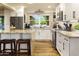 Well-lit kitchen with stainless steel appliances, white cabinets, and an island with bar seating at 4836 E Moonlight Way, Paradise Valley, AZ 85253