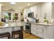 A chef's kitchen with stainless appliances, granite countertops, and decorative backsplash at 4836 E Moonlight Way, Paradise Valley, AZ 85253