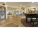 Expansive living room with hardwood floors, stone accents, wet bar and views to the rear yard at 4836 E Moonlight Way, Paradise Valley, AZ 85253