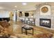 Cozy living room with a stone fireplace, hardwood floors, wet bar, and comfortable seating at 4836 E Moonlight Way, Paradise Valley, AZ 85253