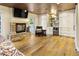 Open living room featuring stone fireplace, wet bar, hardwood floors, and natural light at 4836 E Moonlight Way, Paradise Valley, AZ 85253