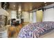 Spacious bedroom with a stone fireplace, dry bar, and wood-look floors at 4836 E Moonlight Way, Paradise Valley, AZ 85253