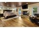 Bedroom with stone fireplace, sitting area, and hardwood floors at 4836 E Moonlight Way, Paradise Valley, AZ 85253