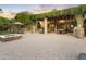 Charming outdoor living space with a fire pit, patio, fireplace, pergola and lush greenery at 4836 E Moonlight Way, Paradise Valley, AZ 85253