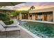 Outdoor living space featuring a pool, spa, desert landscape, and outdoor kitchen area at 4836 E Moonlight Way, Paradise Valley, AZ 85253