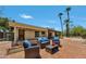 Inviting back patio with brick flooring, a seating area, and views of mature trees and palm trees at 5728 E Sharon Dr, Scottsdale, AZ 85254