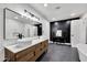 Modern bathroom with dual sinks, a makeup vanity, and black accent wall at 5728 E Sharon Dr, Scottsdale, AZ 85254